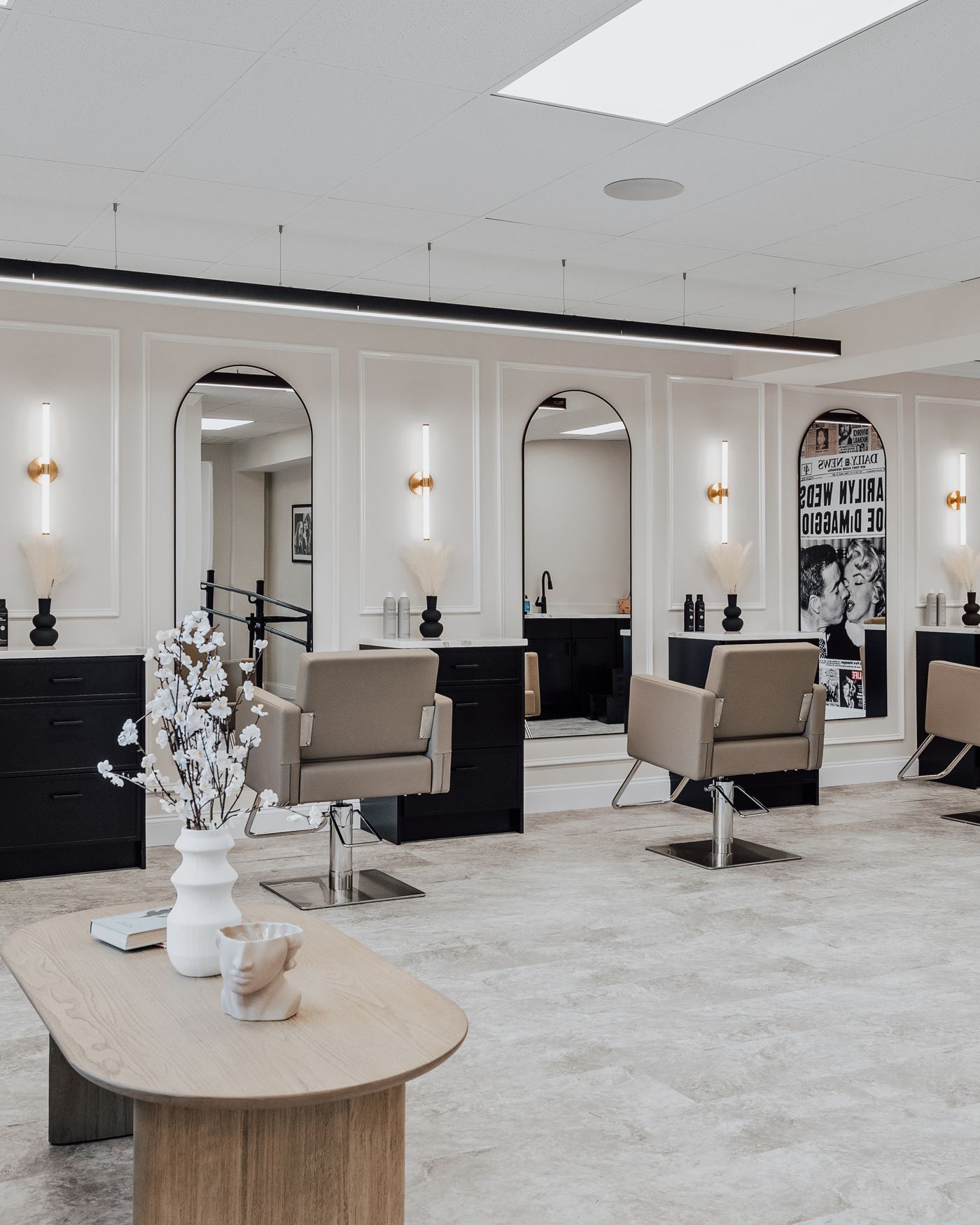 Styling stations beneath arched mirrors at Vintage Roots Salon